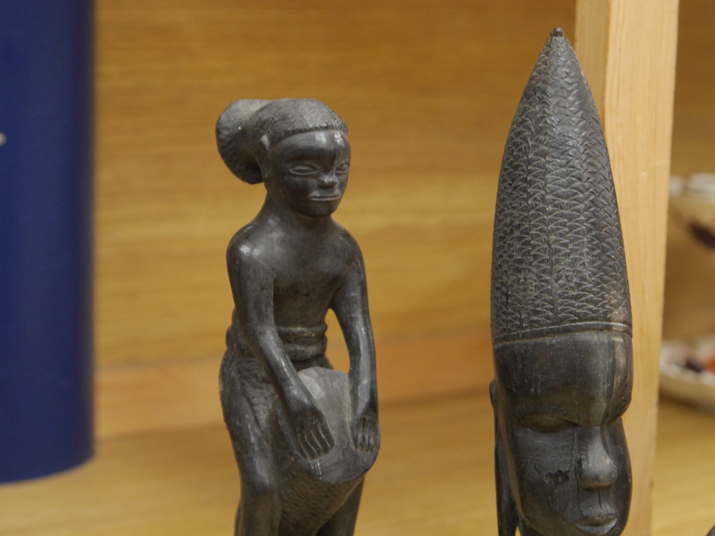 Four African wood carvings to include a figure and a pair and another bust, tallest 27cm. Condition - fair to good